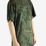 Green t-shirt worn by a person, showing the t-shirt's fit