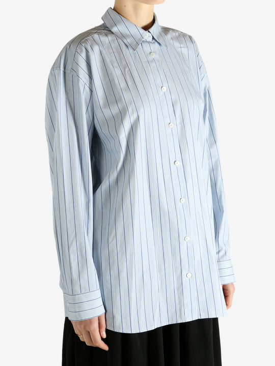 Blue shirts worn by a person, showing the shirts fit