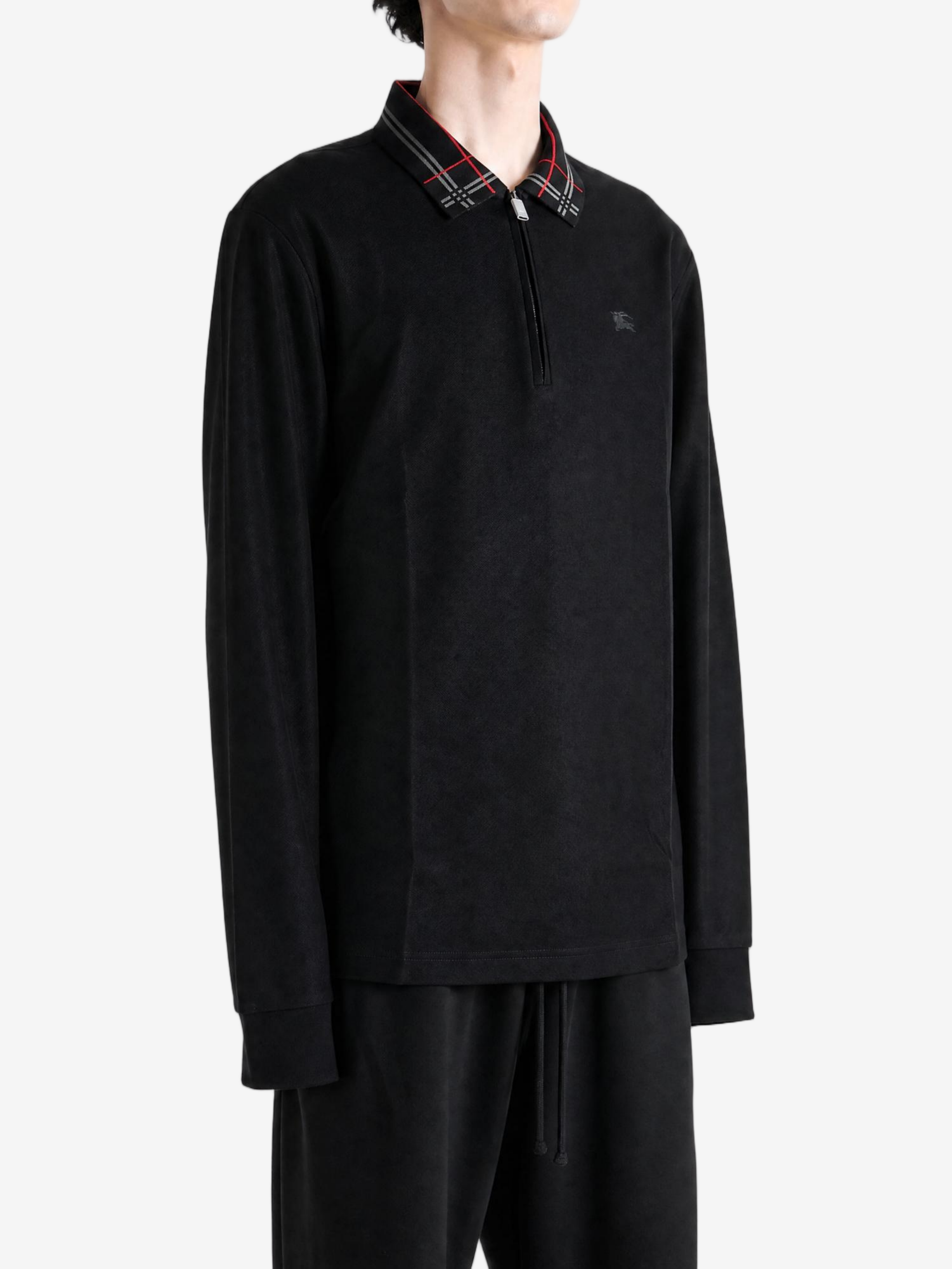 Black top worn by a person, showing the top fit