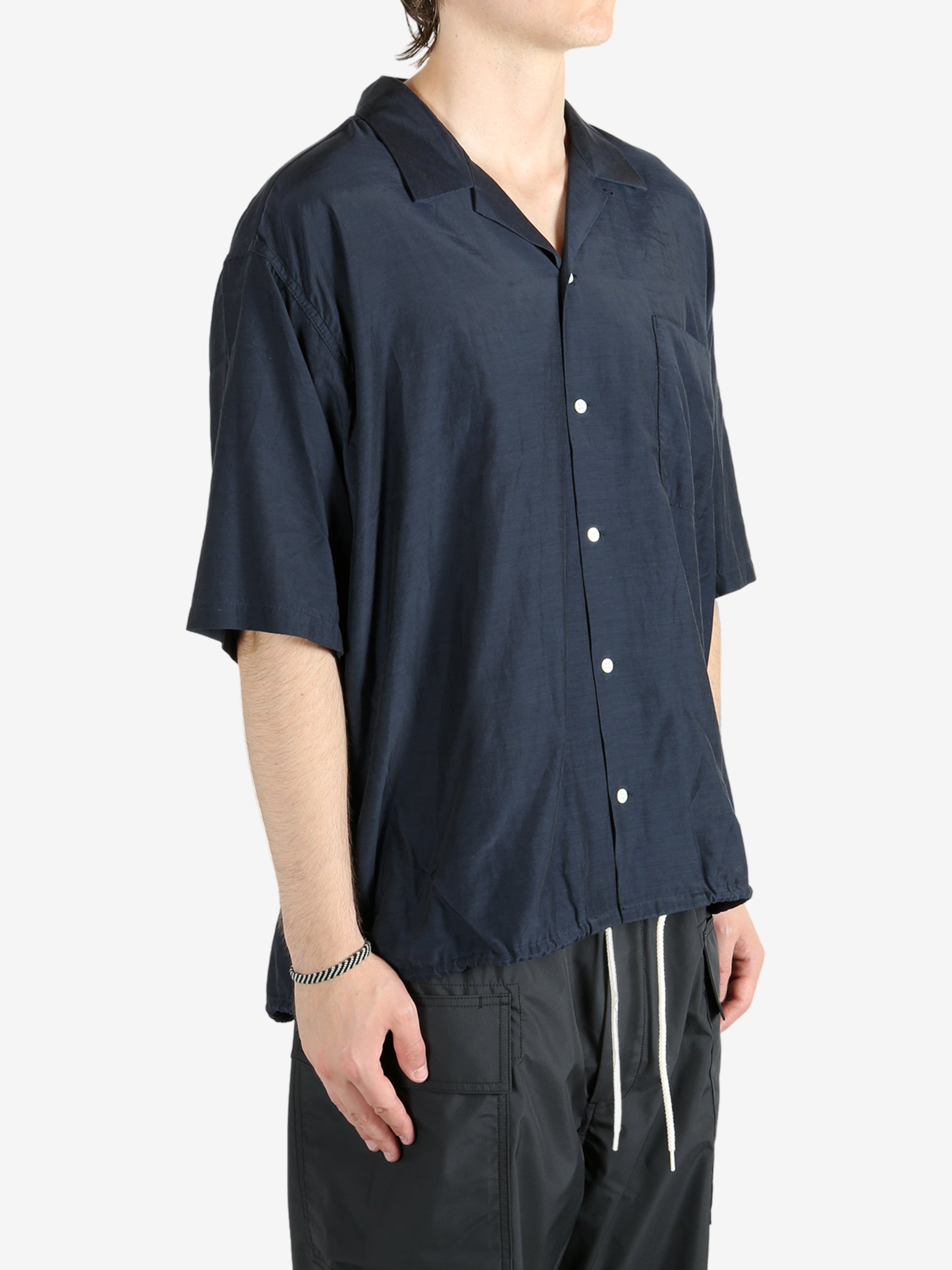 Blue shirt worn by a person, showing the shirt's fit