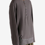 Brown long-sleeve shirt worn by a person, showing the shirt's fit