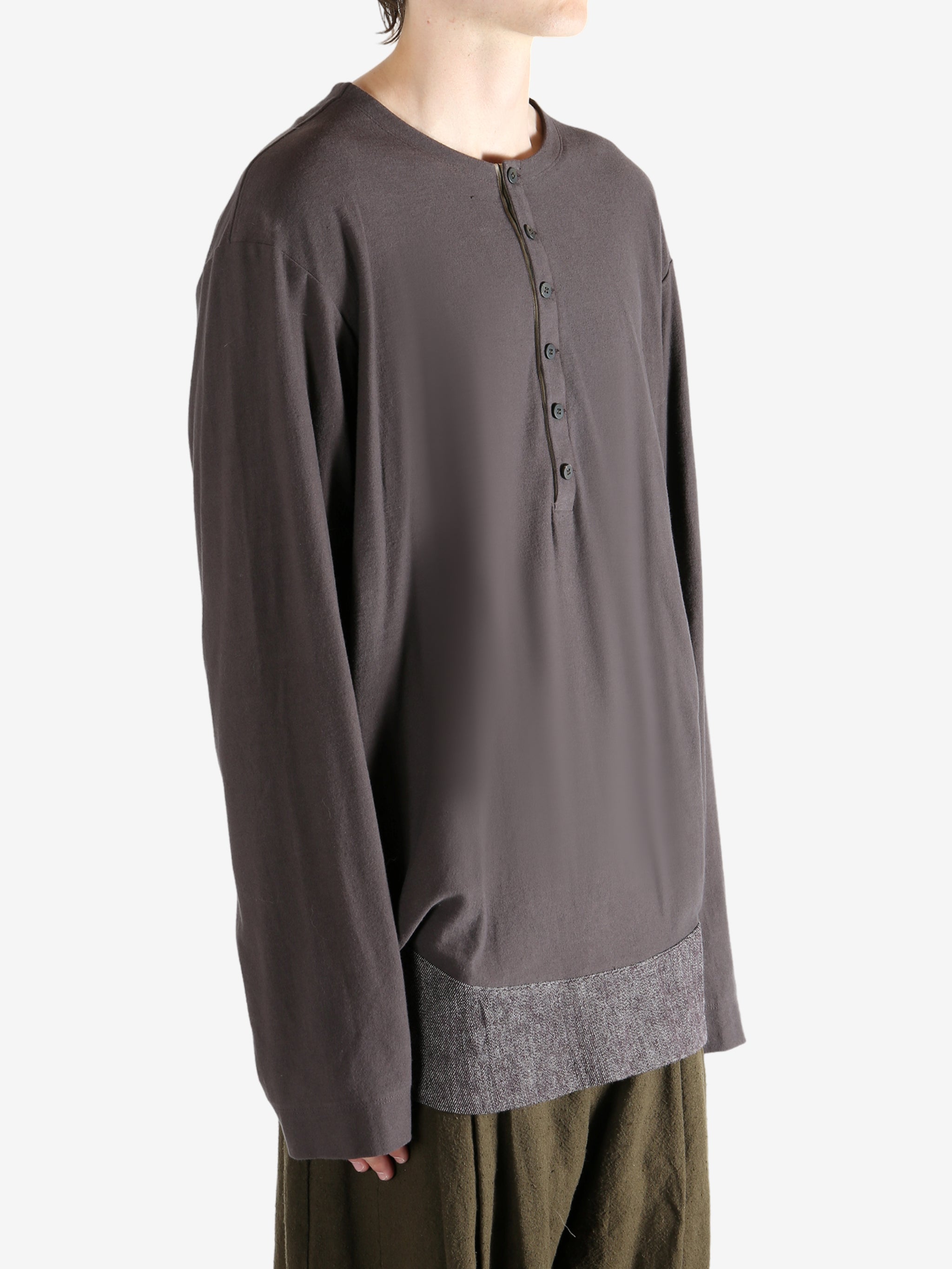 Brown long-sleeve shirt worn by a person, showing the shirt's fit