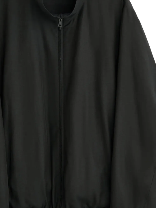 Close up of black jacket , showing texture of the Cupro and Cotton fabric
