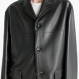 Close up of the black jacket, showing texture of the leather fabric