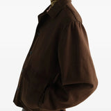 Brown jacket worn by a person, showing the jacket fit