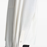 Close up of white shirts, showing texture of the cotton and silk fabric