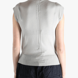 White top worn by a person, showing the top's fit