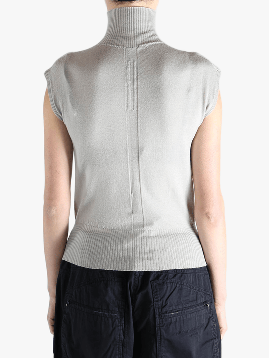 White top worn by a person, showing the top's fit