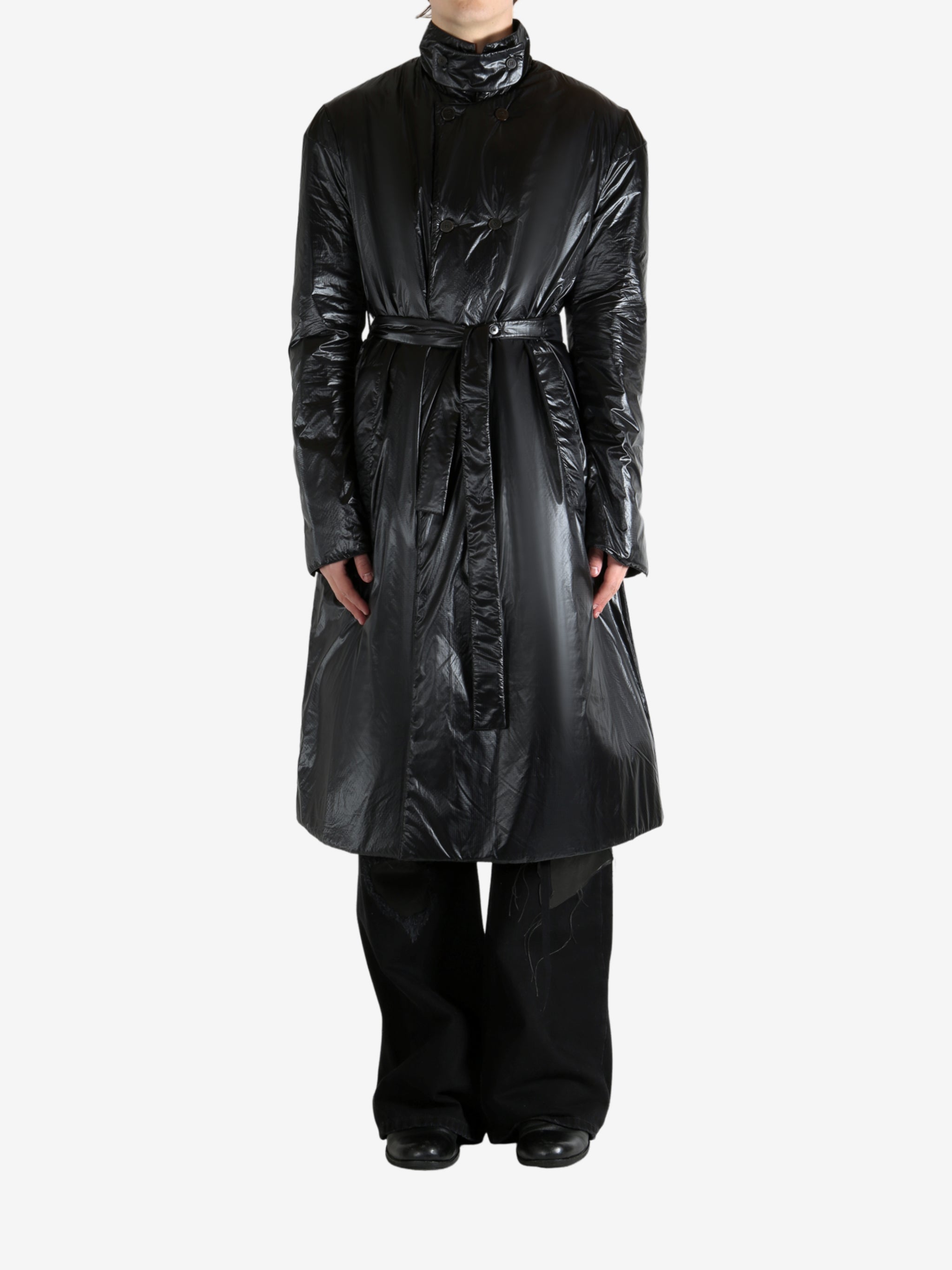 Black coat worn by a person, showing the coat's fit