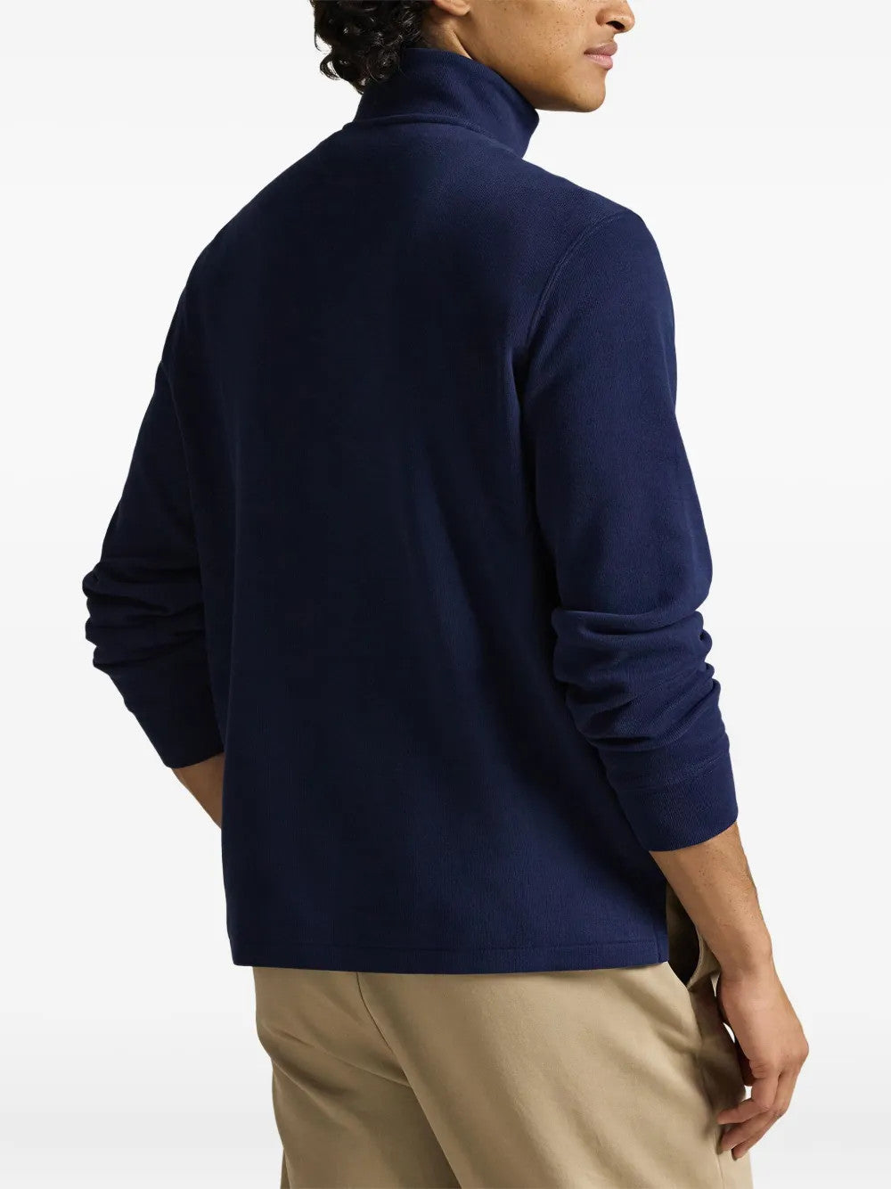 Navy knitwear worn by a person, showing the knitwear fit