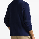 Navy knitwear worn by a person, showing the knitwear fit