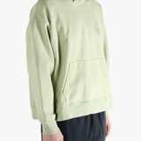 Green hoodie worn by a person, showing the hoodie's fit