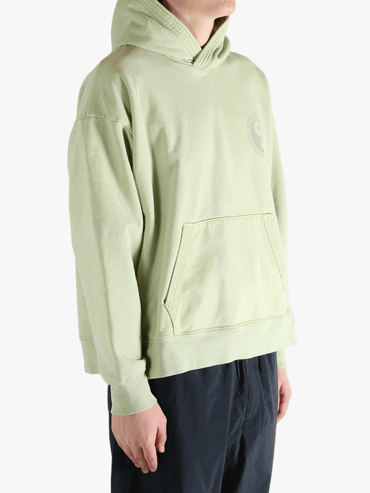 Green hoodie worn by a person, showing the hoodie's fit