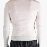 White top worn by a person, showing the top fit