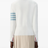 White cardigan worn by a person, showing the cardigan fit