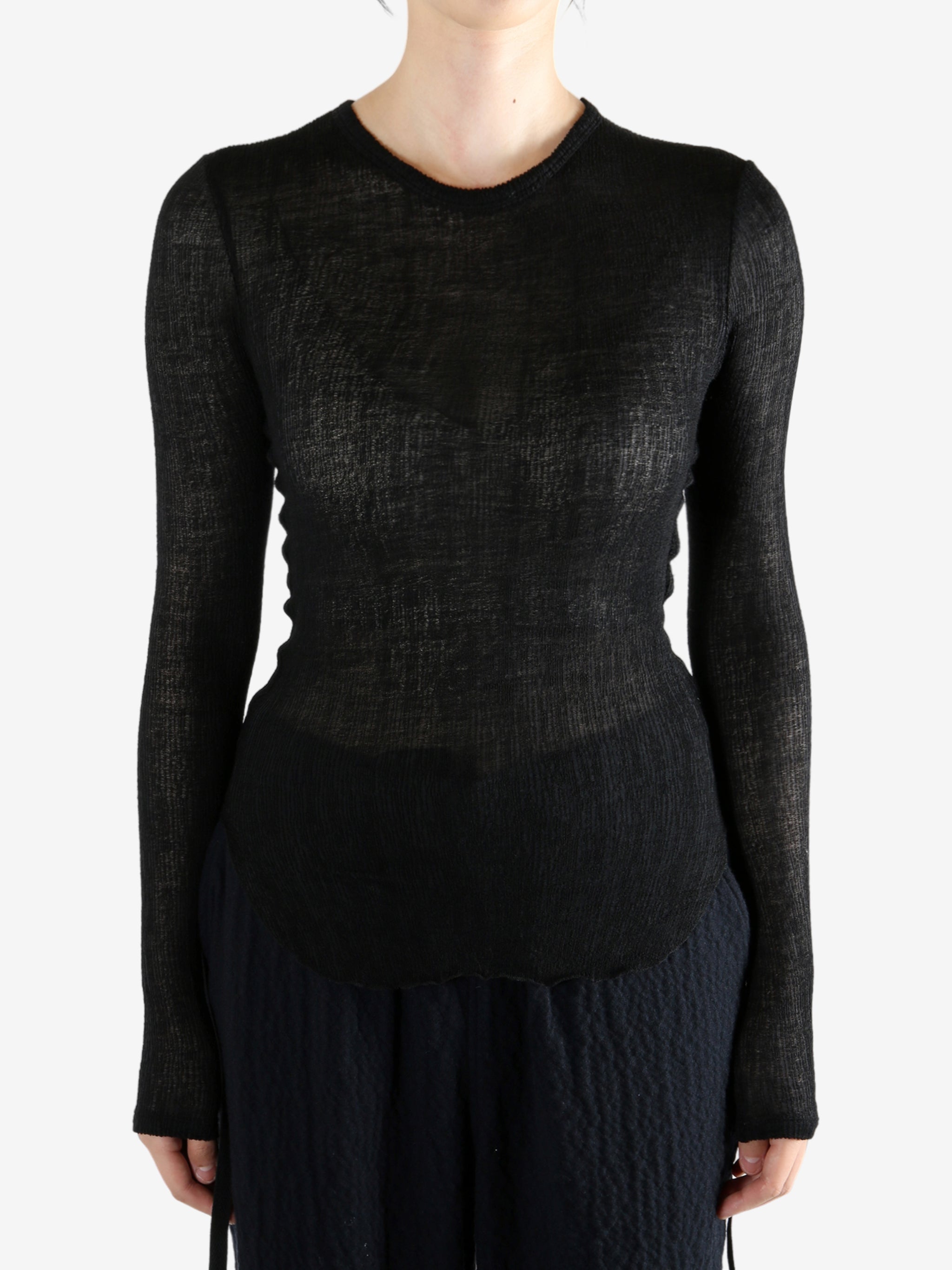 Black topworn by a person, showing the top fit