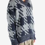 Blue sweater worn by a person, showing the sweater fit