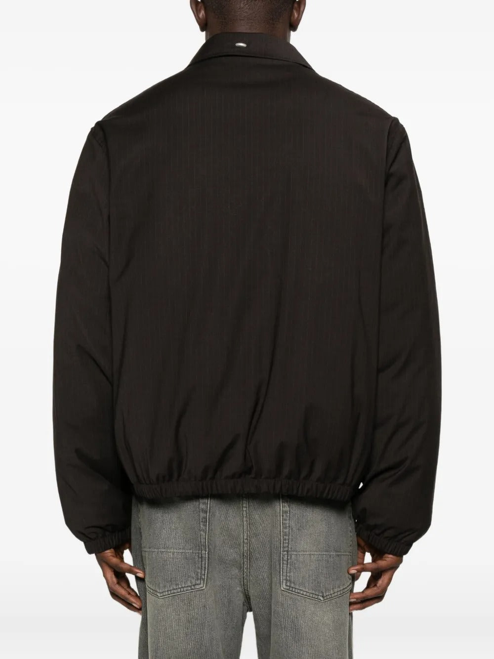 Brown coat worn by a person, showing the coat's fit