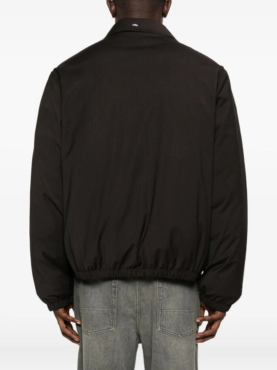 Brown coat worn by a person, showing the coat's fit