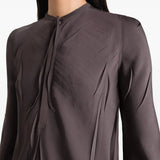Close up of brown dresses, showing texture of the viscose and polyester fabric