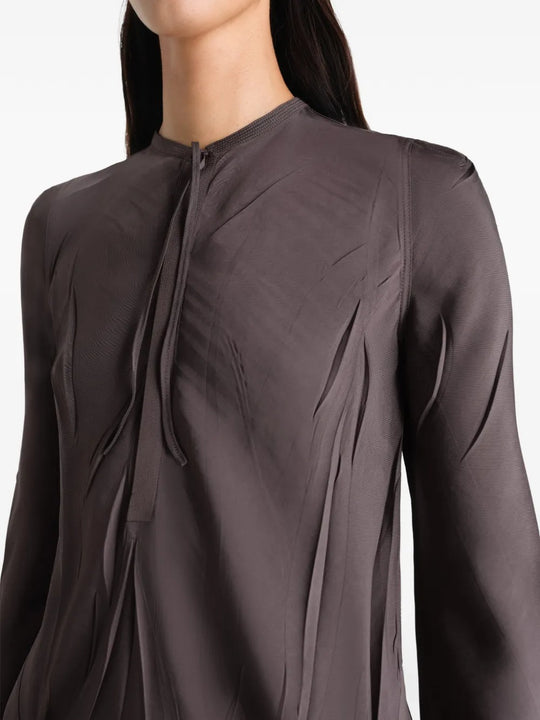 Close up of brown dresses, showing texture of the viscose and polyester fabric
