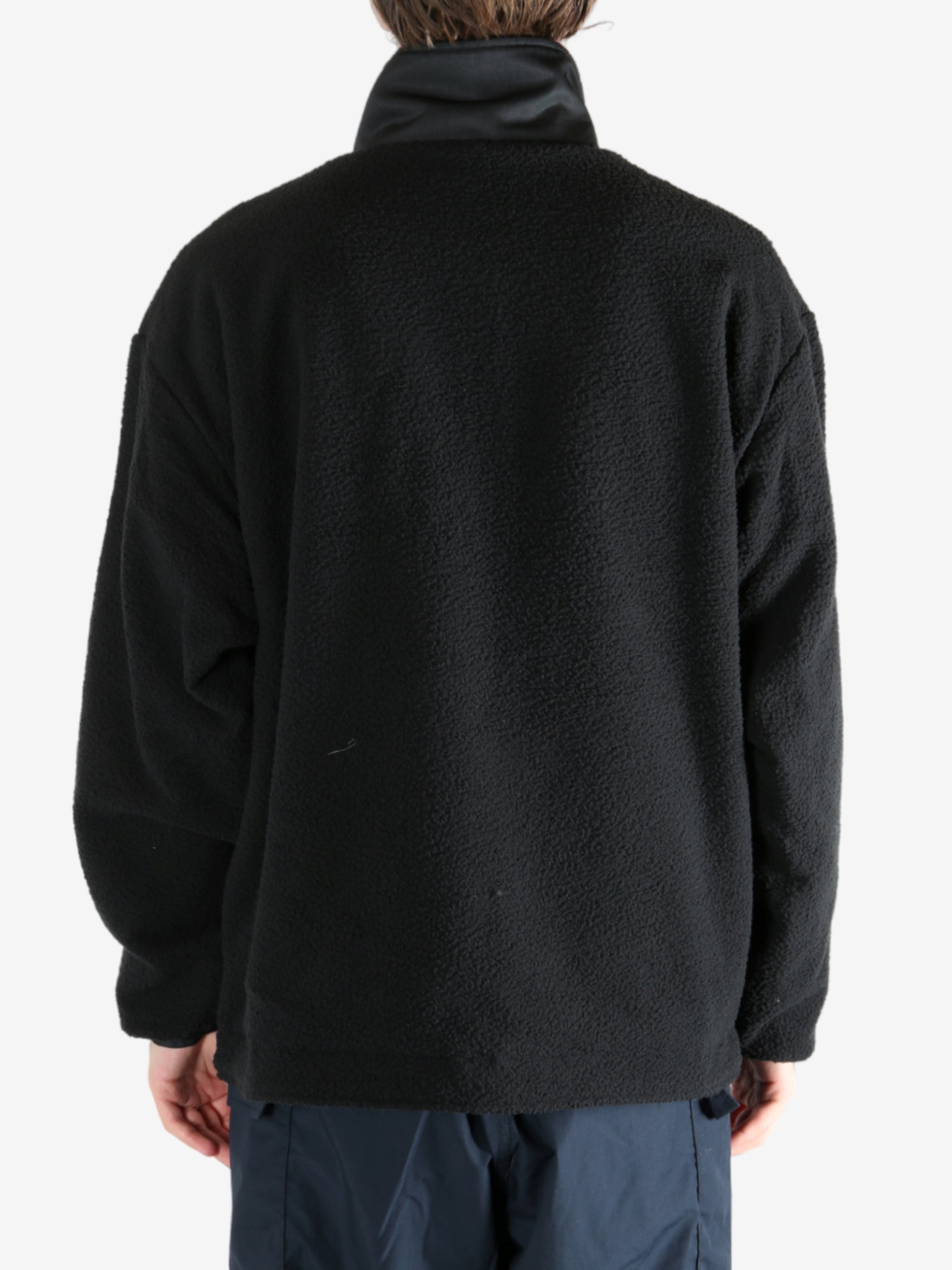 Black jacket worn by a person, showing the jacket's fit