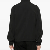 Black jacket worn by a person, showing the jacket fit