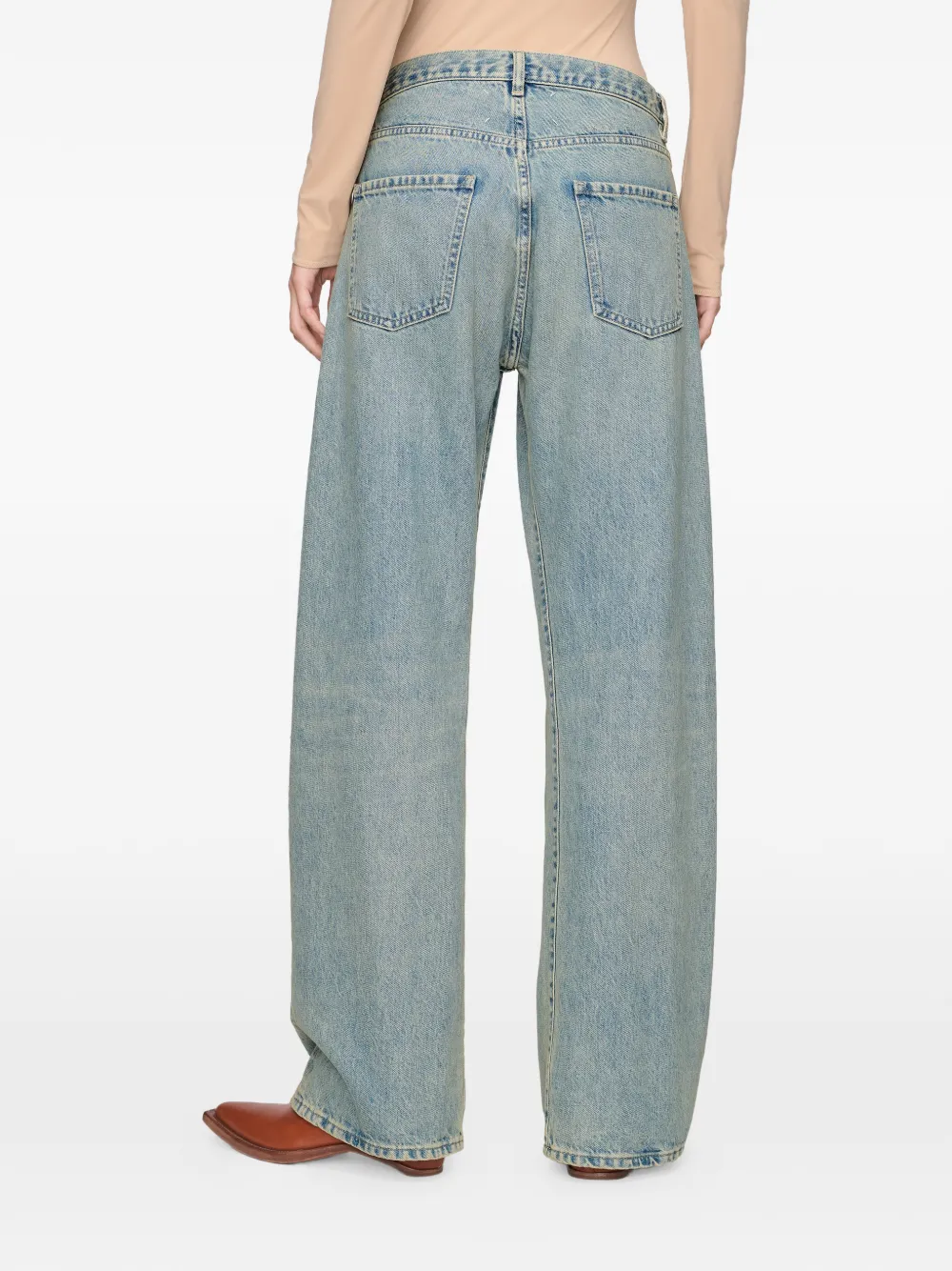 Blue jeans worn by a person, showing the jeans fit