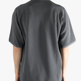 Gray shirt worn by a person, showing the shirt fit