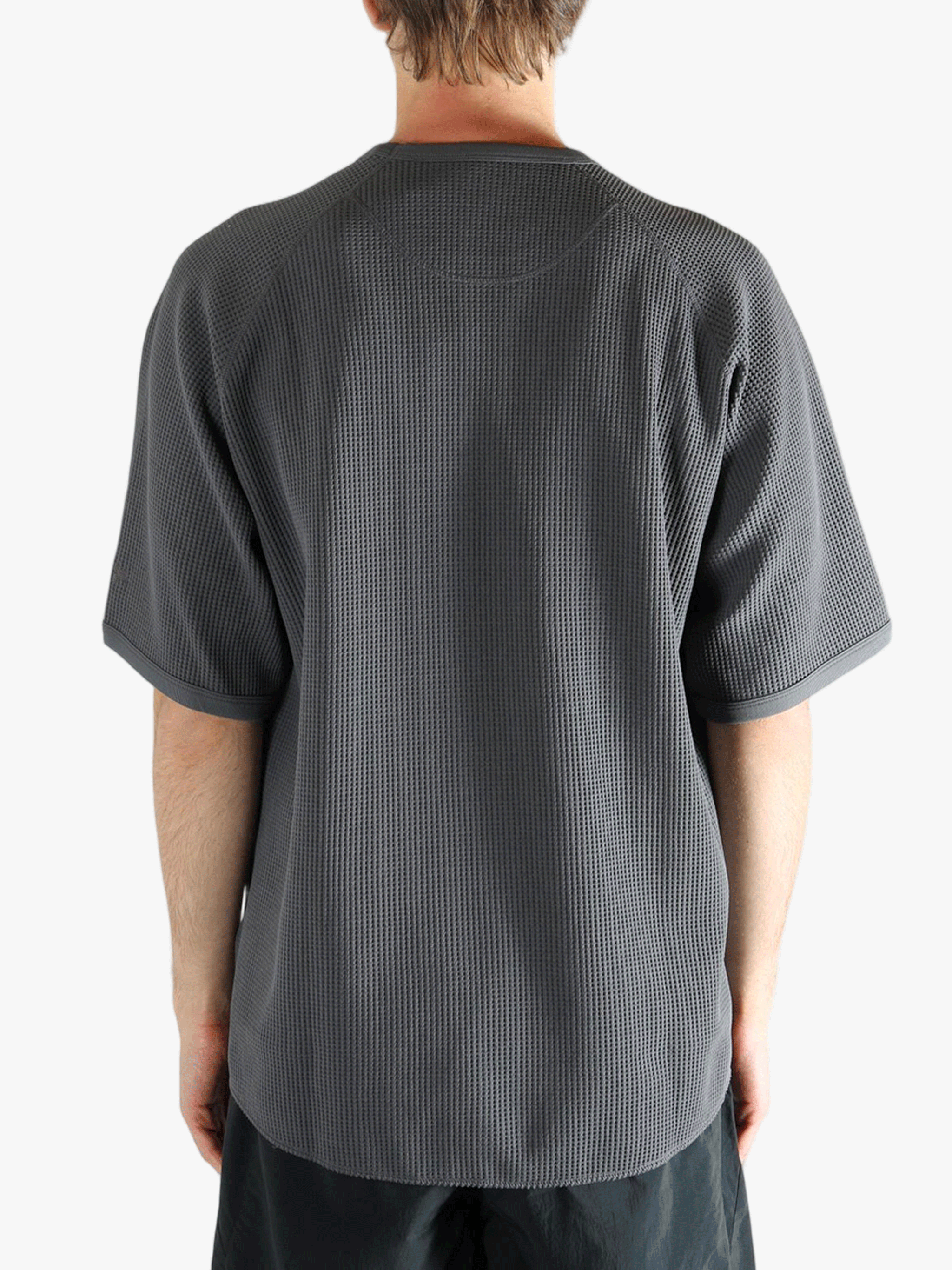 Gray shirt worn by a person, showing the shirt fit