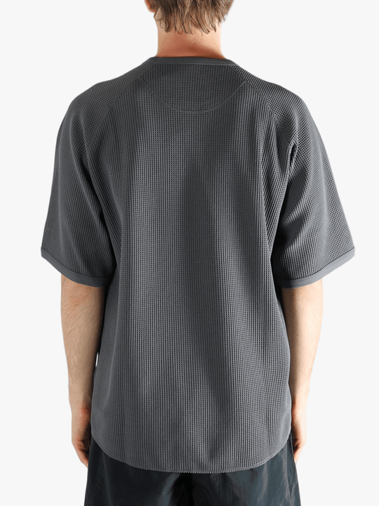 Gray shirt worn by a person, showing the shirt fit