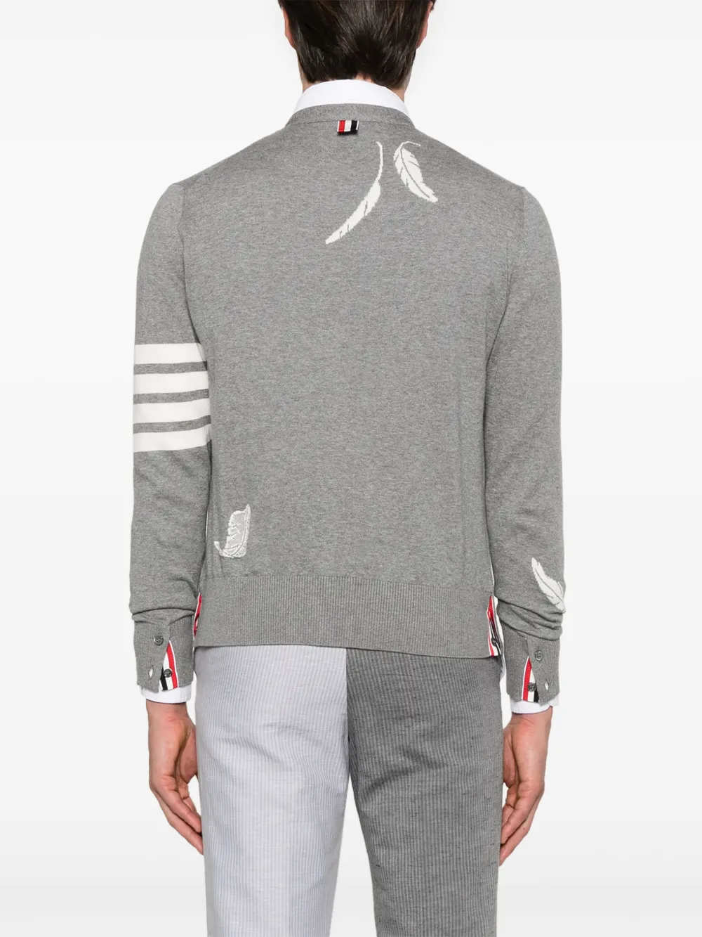 Grey knitwear worn by a person, showing the knitwear fit