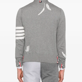 Grey knitwear worn by a person, showing the knitwear fit