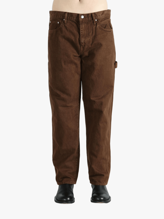 Brown pants worn by a person, showing the pants fit