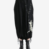 Black pants worn by a person, showing the pants fit