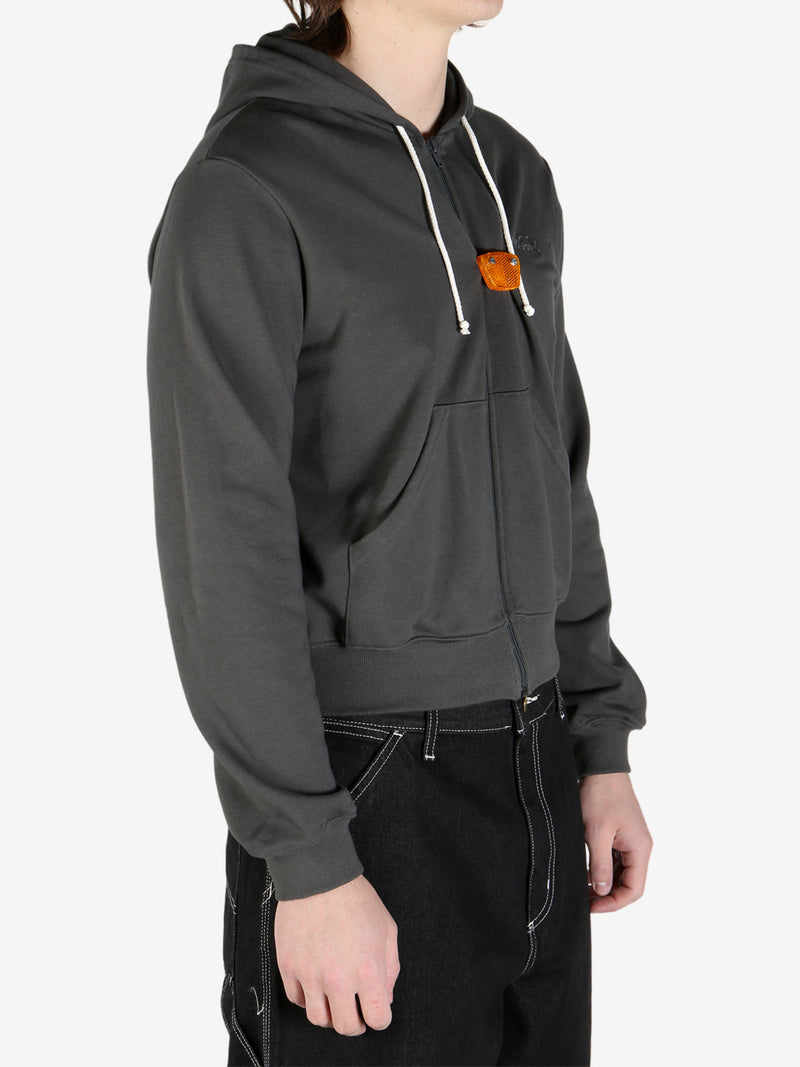 Grey hoodie  worn by a person, showing the hoodie's fit