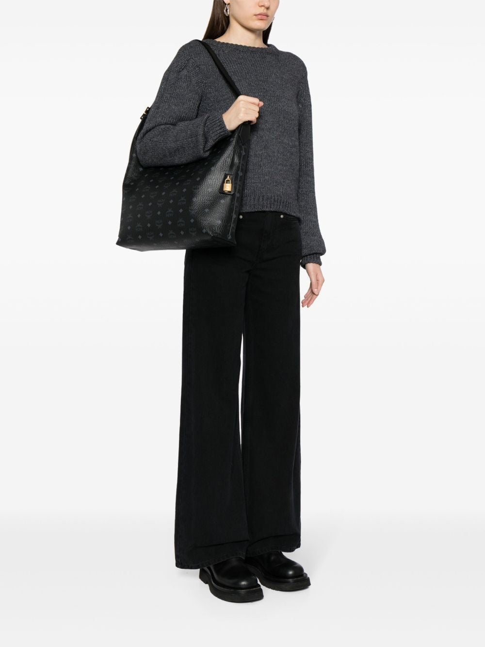Black bag carried by a person, showing the bag’s fit