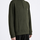 Green knitwear worn by a person, showing the knitwear fit