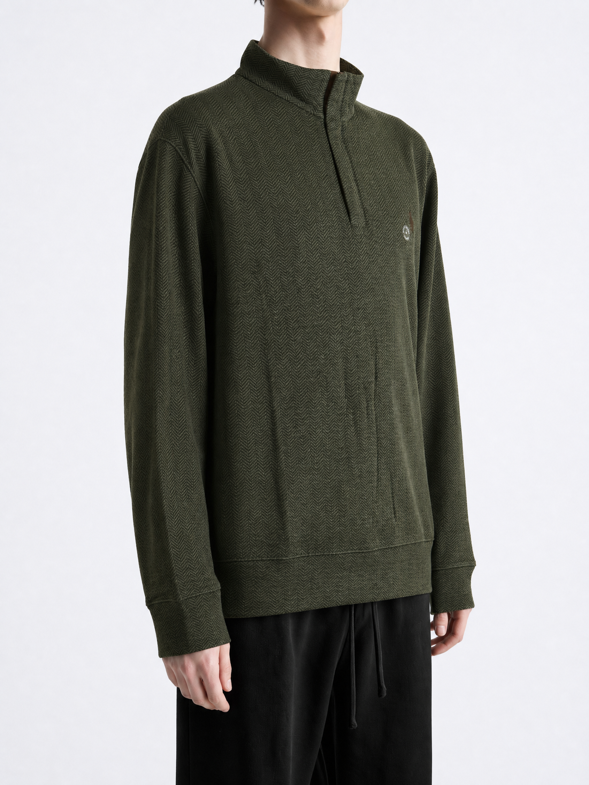 Green knitwear worn by a person, showing the knitwear fit