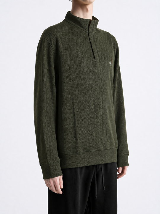 Green knitwear worn by a person, showing the knitwear fit