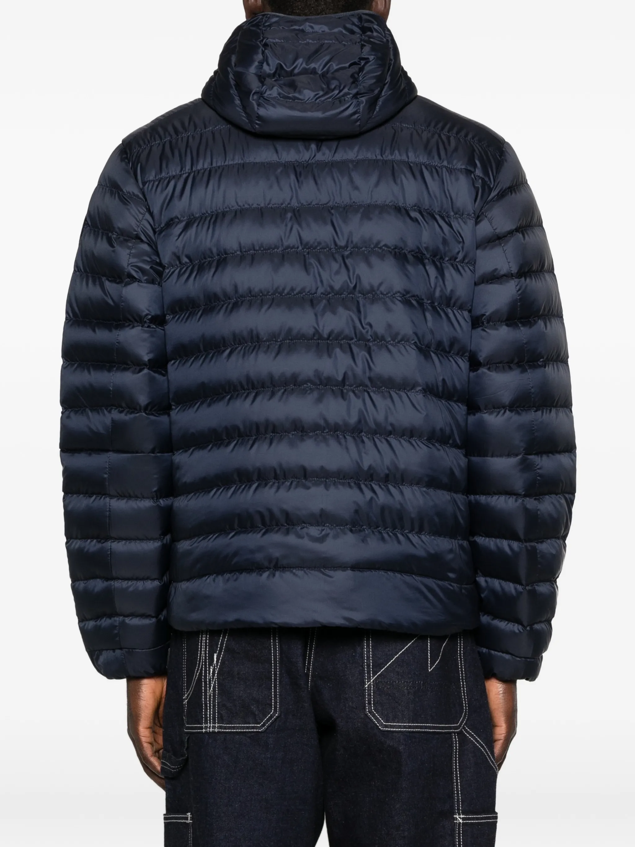 navy jacket worn by a person, showing the jacket fit