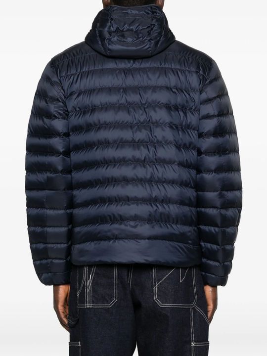 navy jacket worn by a person, showing the jacket fit