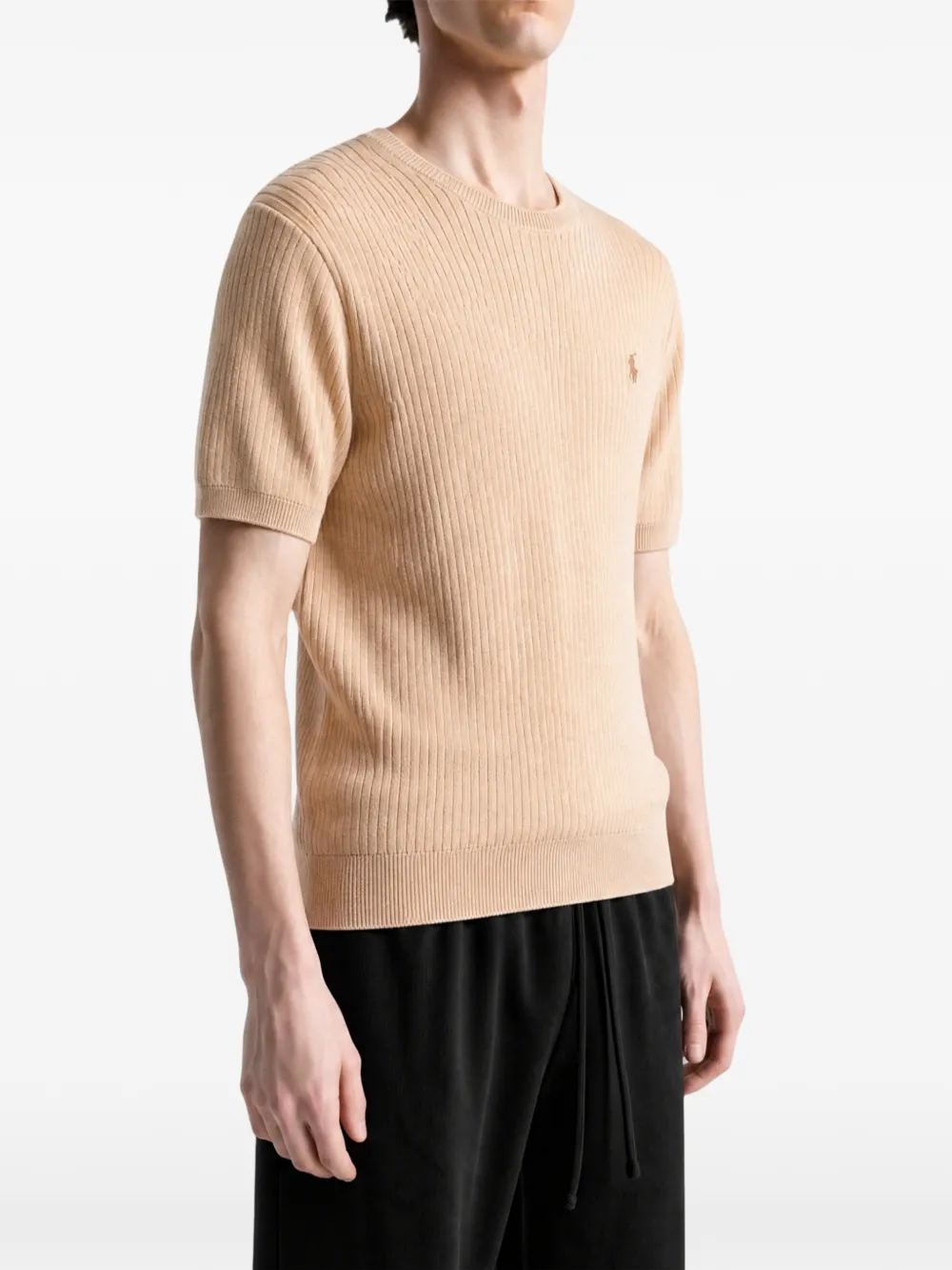 Tan hoodie worn by a person, showing the hoodie fit