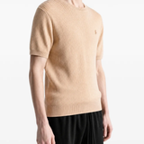 Tan hoodie worn by a person, showing the hoodie fit