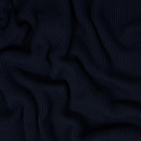 Close up of black polo shirt, showing texture of the cotton fabric
