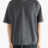 Gray shirt worn by a person, showing the shirt fit