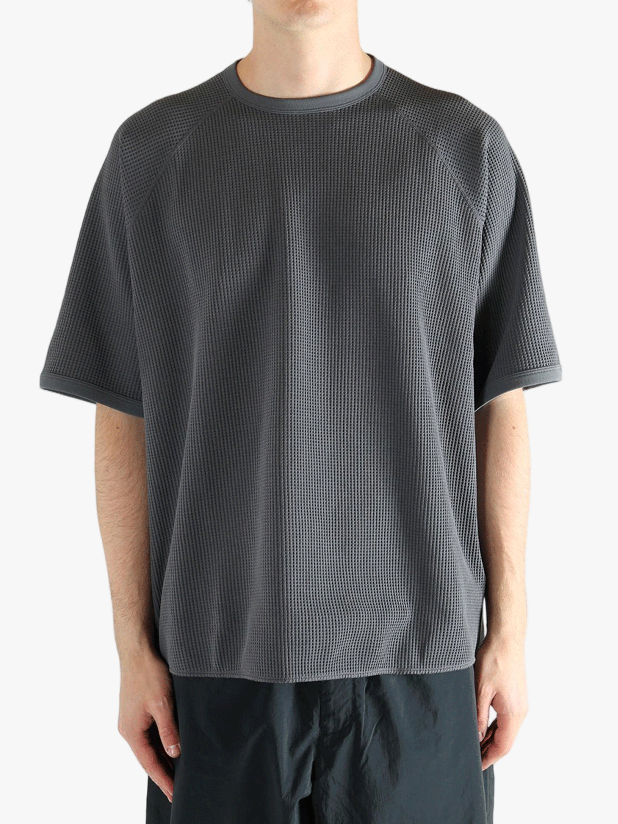 Gray shirt worn by a person, showing the shirt fit