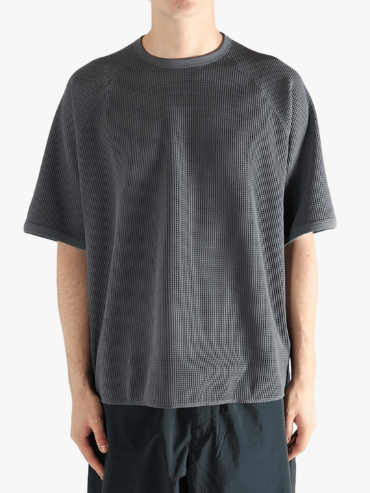 Gray shirt worn by a person, showing the shirt fit