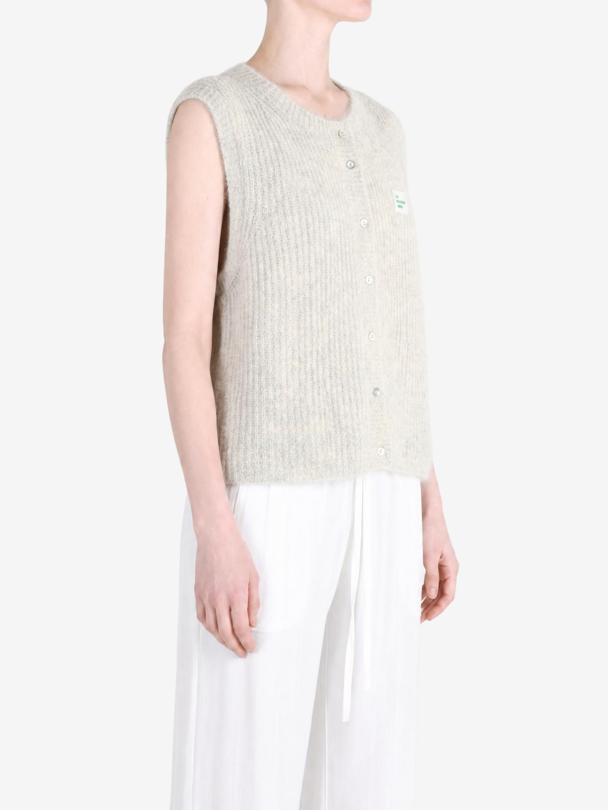 Tan knitwear worn by a person, showing the knitwear fit
