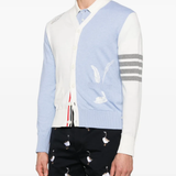 Blue knitwear worn by a person, showing the knitwear's fit